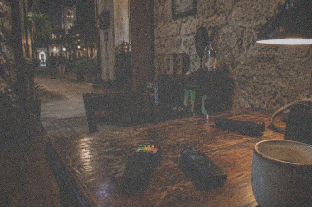 Ghost hunting equipment resting on a table inside a dim historic building
