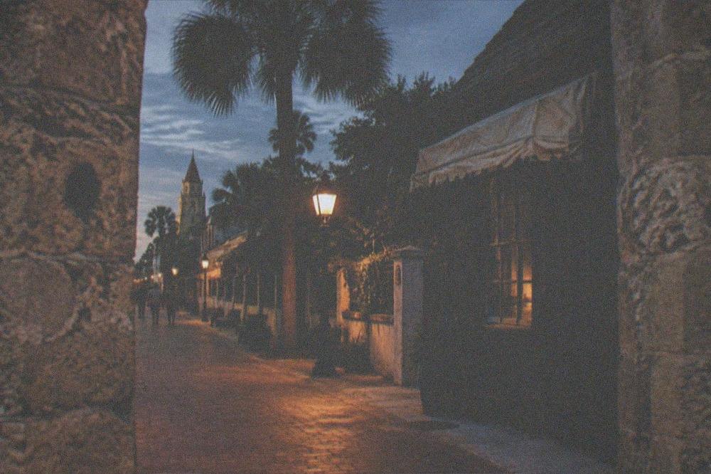 Night falling over a downtown St. Augustine street with historic buildings