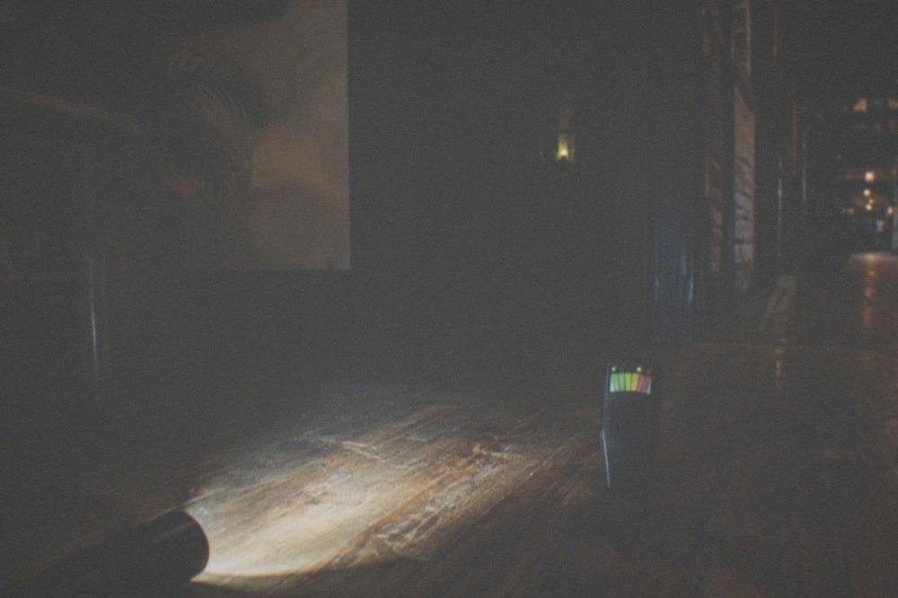 Paranormal investigation equipment resting on an old wooden floor